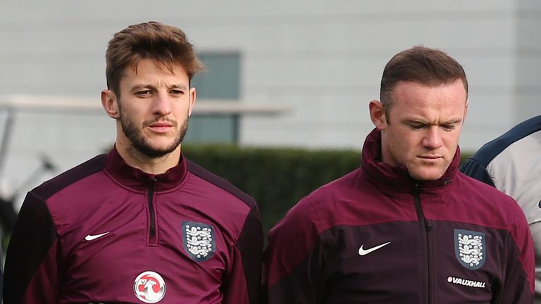 England players Adam Lallana (L) and captain Wayne Rooney
