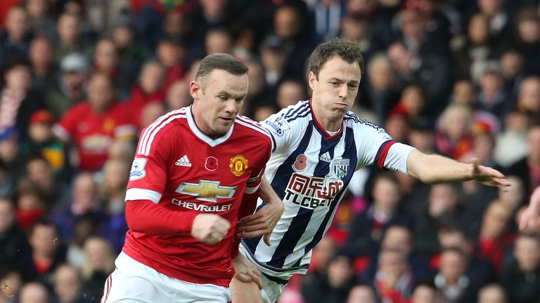 Wayne Rooney (L) of Manchester United in action with Jonny Evans of West Bromwich Albion