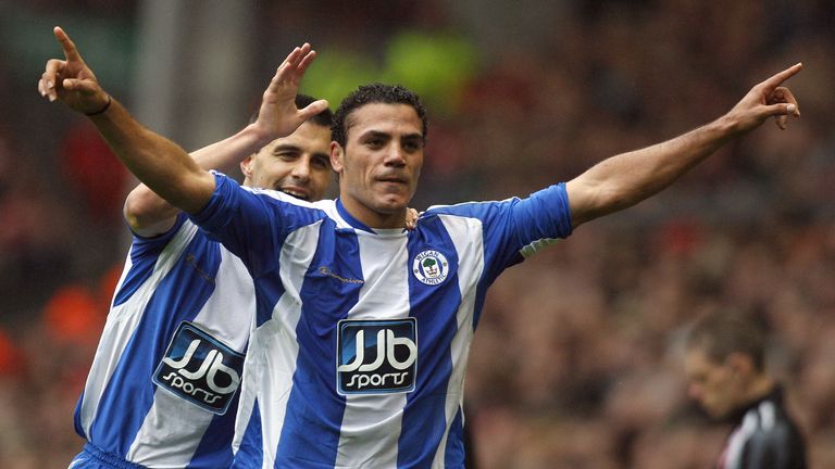 Egyptian forward Amr Zaki (r) scores one of two goals for Wigan at Anfield. 