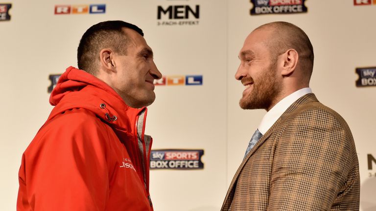 Tyson Fury and Wladimir Klitschko stare off during a press conference at Rheinterassen on November 24