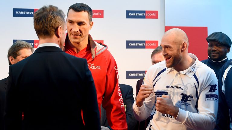 Tyson Fury of UK jokes next to Wladimir Klitschko of Ukraine during the weigh in at Karstadt Sport 