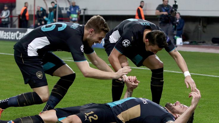 Olivier Giroud celebrates his second goal with Aaron Ramsey and Mesut Ozil in Arsenal's 3-0 win at Olympiakos in December 2015