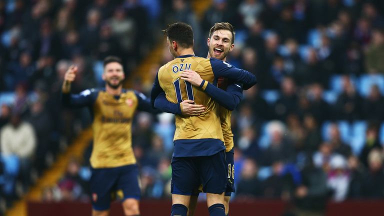 BIRMINGHAM, ENGLAND - DECEMBER 13:  Aaron Ramsey of Arsenal (R) celebrates as he scores their second goal with team mate Mesut Ozil during the Barclays Pre