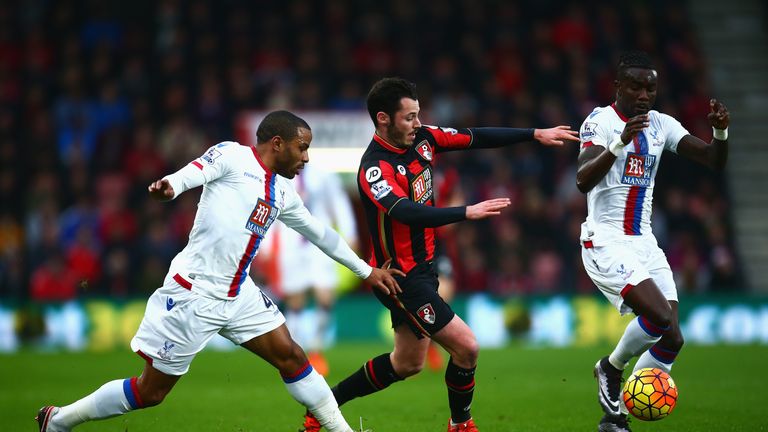 Adam Smith of Bournemouth challenges Pape Souare (R) and Jason Puncheon of Crystal Palace 