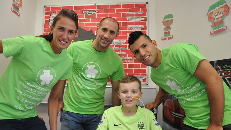 Manchester City players meet a young fan