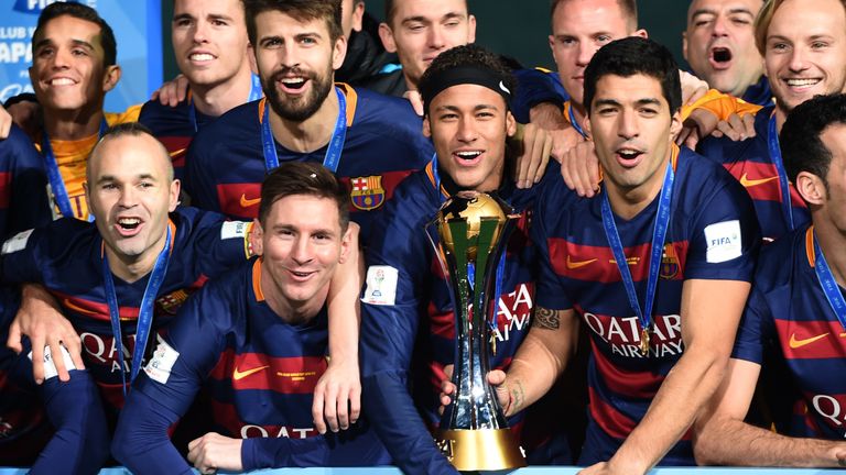 Andres Iniesta, forward Lionel Messi, forward Neymar and forward Luis Suarez celebrates with his teammates around the FIFA Club World Cup trophy 