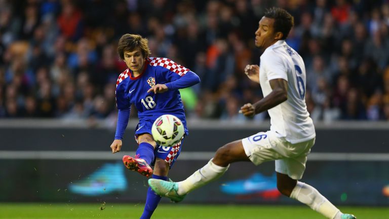 Ante Coric of Croatia shoots past Liam Moore of England during the UEFA U21 Championship Playoff First Leg match  in 2014