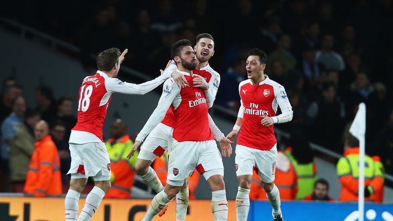 Olivier Giroud of Arsenal celebrates scoring his team's second goal with team mates during the Barclays Premier League match against Man City