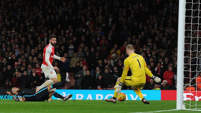 Olivier Giroud shoots past Man City goalkeeper Joe Hart to score Arsenal's second goal in first-half injury-time