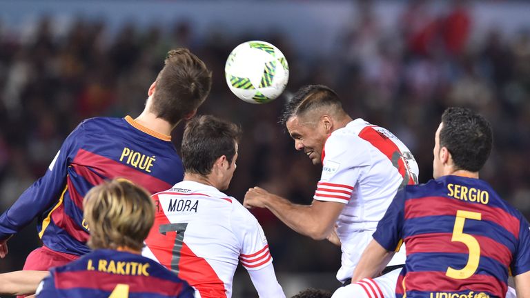 Gabriel Mercado (right) and Gerard Pique challenge for the ball