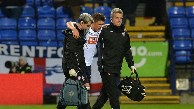 Bolton Wanderer's Max Clayton (centre) leaves the pitch injured.