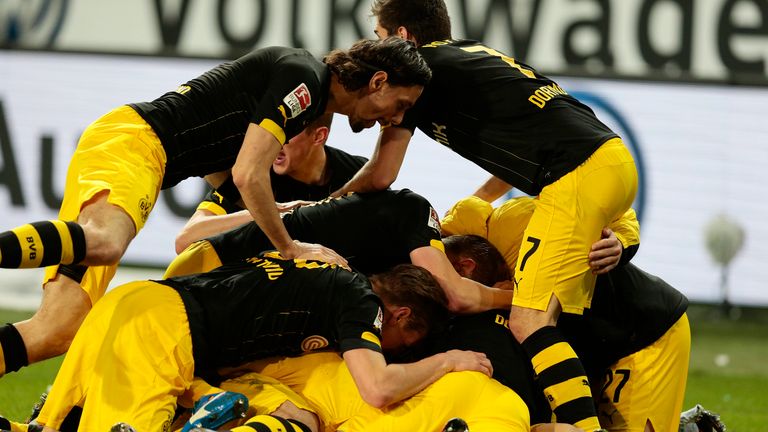 Shinji Kagawa of Dortmund celebrates scoring the winning goal at Wolfsburg with his team mates