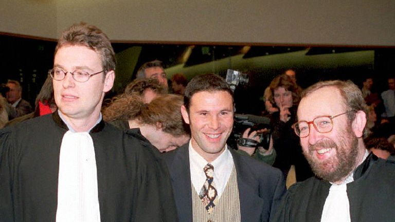 Luxembourg, LUXEMBOURG:  (FILES) Belgian soccer player Jean-Marc Bosman, flanked by two of his lawyers Luc Misson (R) and Jean-Louis Dupont (L), smiles as 