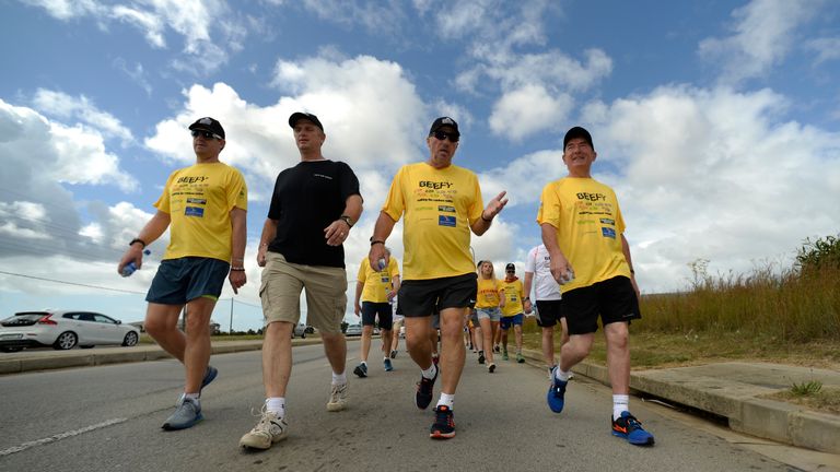 In this handout image provided by Philip Brown, Sir Ian Botham and his supporters walk the 'Beefy Walking the Rainb