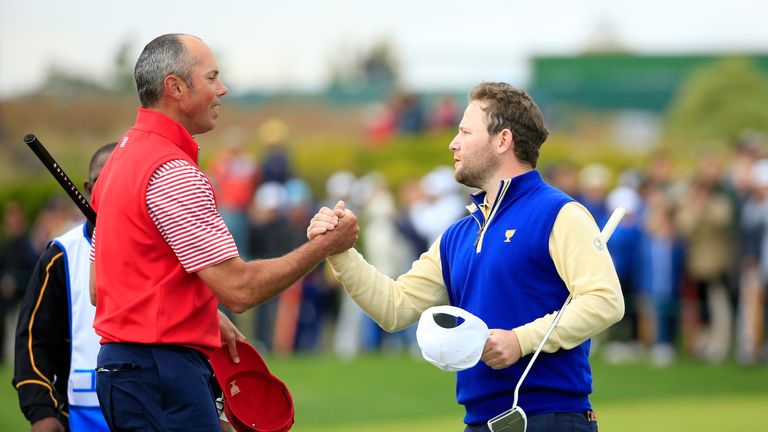 Branden Grace shakes hands with Matt Kuchar after winning his fifth match at the Presidents Cup