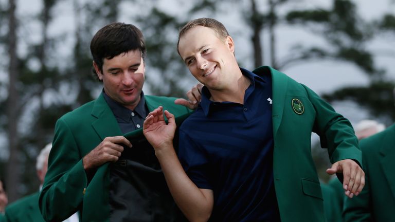 Bubba Watson presents Jordan Spieth of the United States with the green jacket after Spieth won the 2015 Masters Tournament