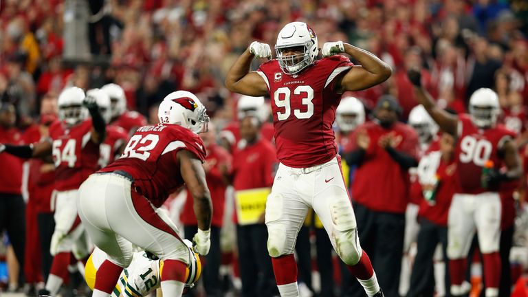 Calais Campbell #93 and Frostee Rucker #92 of the Arizona Cardinals celebrate after a sack on Green Bay Packers quarterback Aaron Rodgers