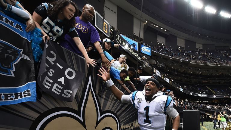 Cam Newton #1 of the Carolina Panthers celebrates with fans following a victory over the New Orleans Saints at the Mercedes