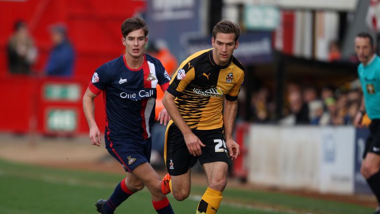 Mickey Demetriou of Cambridge United and Mitchell Lund of Doncaster Rovers in action during the Emirates FA Cup Second Round