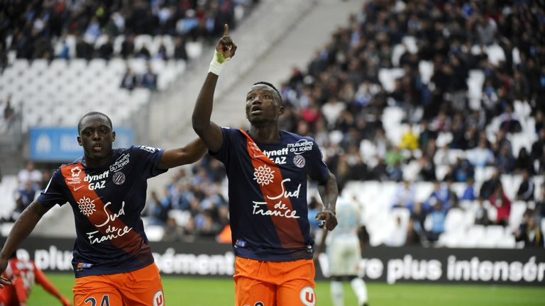 Montpellier's Chadian forward Casimir Ninga (R) celebrates after scoring against Olympique de Marseille at Velodrome Stadium