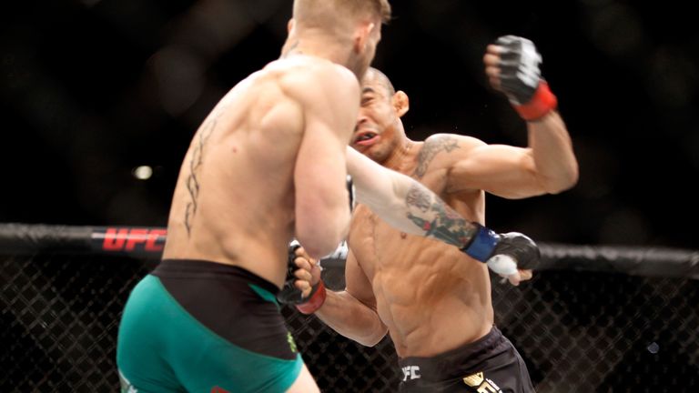 LAS VEGAS, NV - DECEMBER 12:  Conor McGregor (L) knocks out Jose Aldo in the first round of their featherweight title fight during UFC 194 on December 12, 