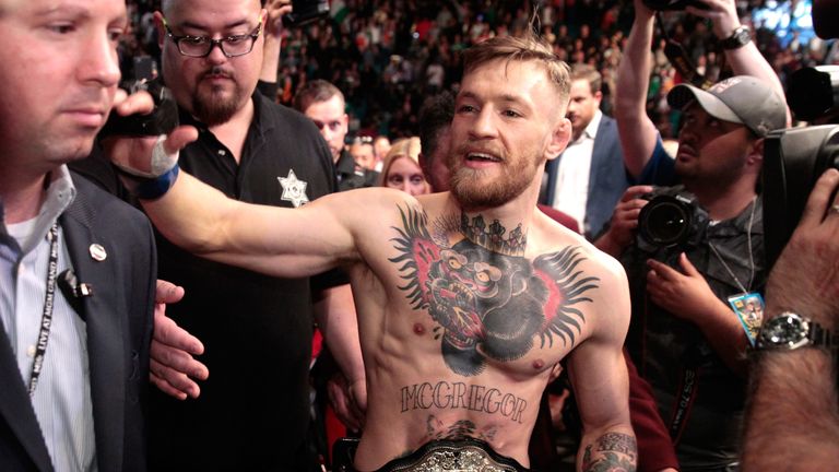 LAS VEGAS, NV - DECEMBER 12:  Conor McGregor leaves the Octagon after his first-round knockout victory over Jose Aldo in their featherweight title fight du