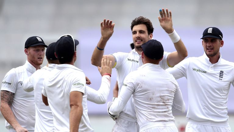 England's bowler Steven Finn (C) celebrates after dismissing South African batsman and Captain Hashim Amla