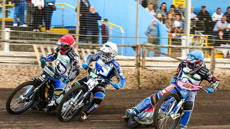 Danny King (red helmet), Ricky Wells (white) and Cameron Heeps race into the first bend of the opening heat of the Ipswich v Workington.