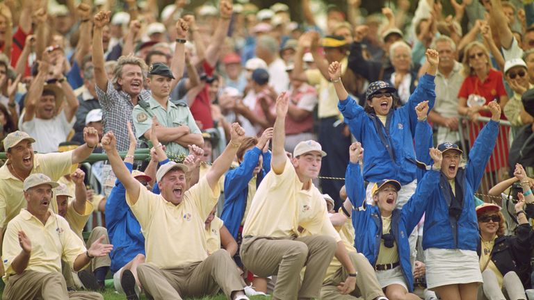 Thomas Bjorn (centre right) celebrates with Darren Clarke after their European team mates claim another point on hole 18  during the opening day fourballs 