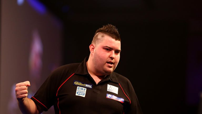 Michael Smith celebrates winning against Mensur Suljovic during the PDC World Darts Championships