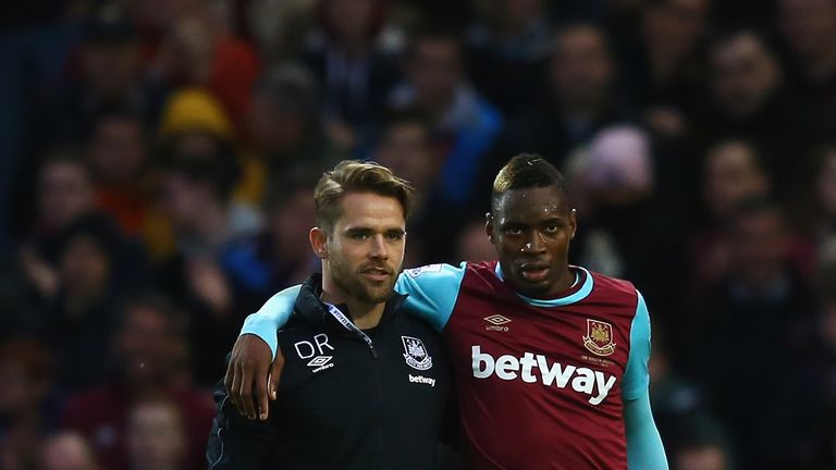 Diafra Sakho is helped off the pitch by physio Dominic Rogan after injuring his thigh in West Ham's draw with West Brom