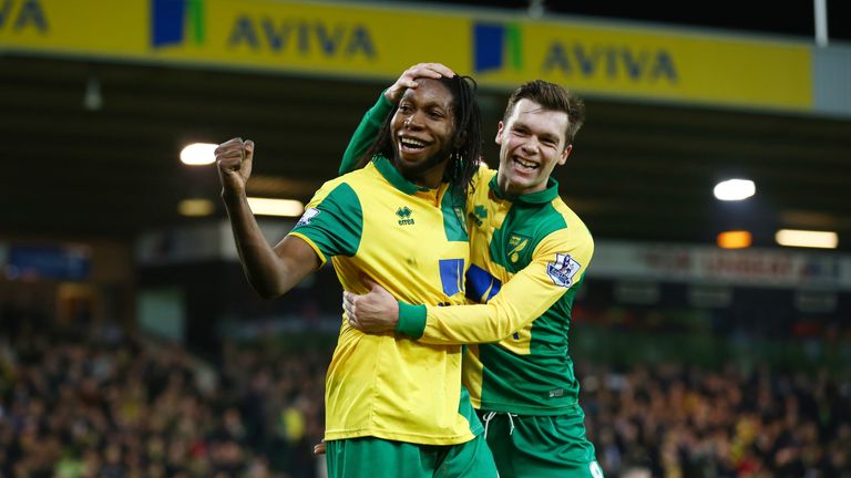 Dieumerci Mbokani (L) celebrates scores Norwich's second goal with Jonny Howson (R) during the Barclays Premier League match against Aston Villa