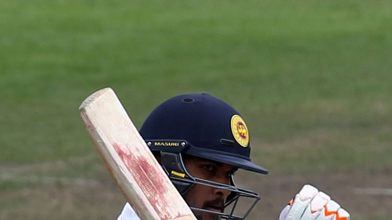 DUNEDIN, NEW ZEALAND - DECEMBER 14: Dinesh Chandimal of Sri Lanka acknowledges his team-mates after scoring 50 runs during day five of the First Test match