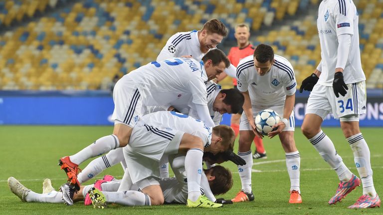 Dynamo's midfielder Denys Harmash is congratulated after he opens scoring during Champions League Group G football match between FC Dynamo Kiev and Maccabi