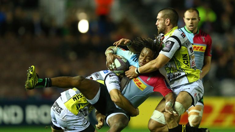Marland Yarde of Harlequins is tackled by Marco Susio of Rugby Calvisano 