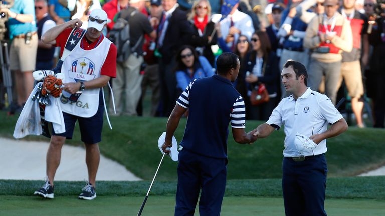 Francesco Molinari shakes hands with Tiger Woods after halving their Sunday singles tie to give Europe 2012 victory