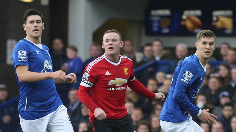 Wayne Rooney in action with Gareth Barry and John Stones during Premier League match between Everton and Manchester United