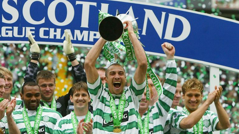 Celtic's Henrik Larsson celebrates with the trophy 