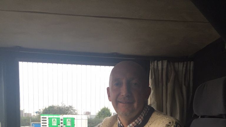 Ian Holloway in the drivers seat of the 10 in 10 bus, complete with a Christmas knit.