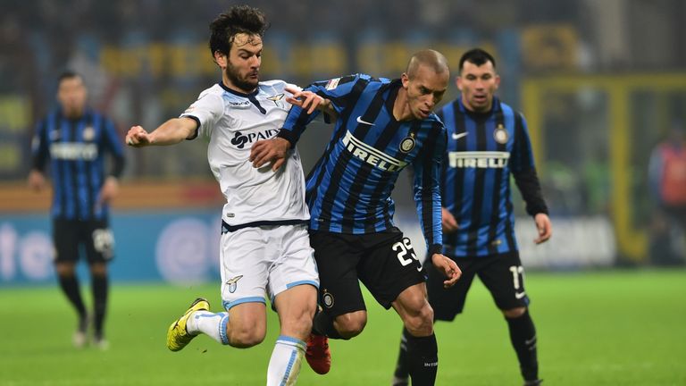 Inter Milan's defender from Brazil Joao Miranda (R) fights for the ball with Lazio's midfielder from Italy Marco Parolo 