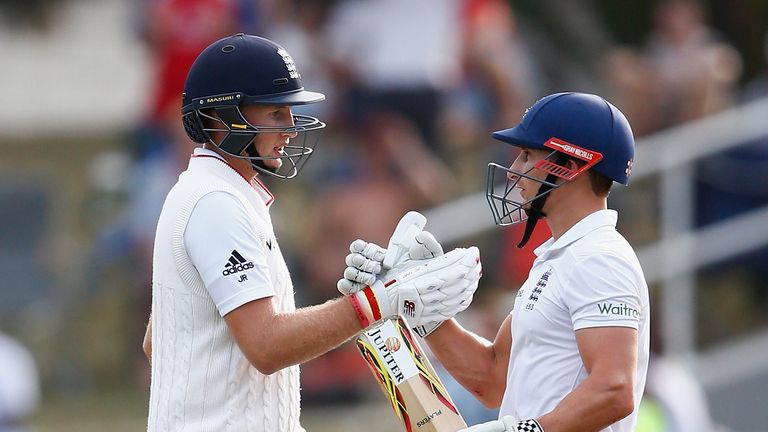 James Taylor of England congratulates Joe Root of England after he reached his 50 runs