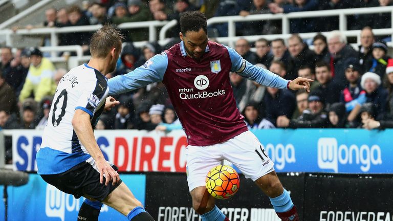 Joleon Lescott of Aston Villa and Siem de Jong of Newcastle compete for possession