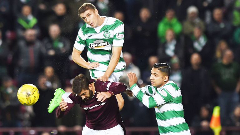 Juanma of Hearts is challenged by Jozo Simunovic and Emilio Izaguirre of Celtic 