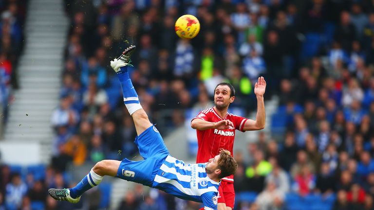 Dale Stephens of Brighton clears the ball from Kike