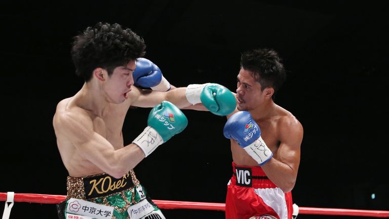 Champion Kosei Tanaka (L) of Japan and Vic Saludar (R) of Philippines exchange fights during the WBO minimum weight title match