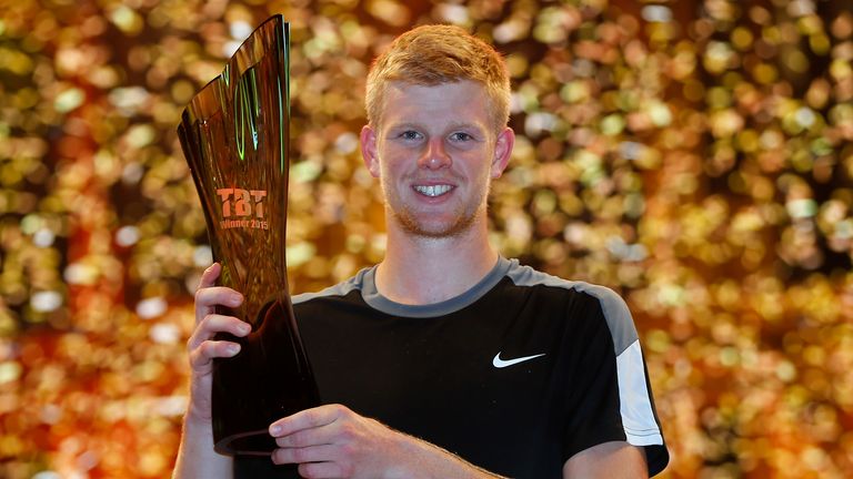 Kyle Edmund of Great Britain lifts the trophy after winning his Tie Break Tens singles match against Andy Murray