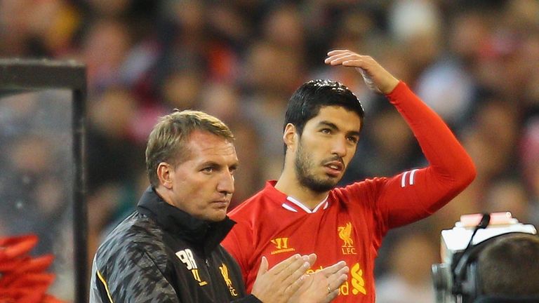Liverpool FC Manager Brendan Rodgers (L) looks on as Luis Suarez of Liverpool i