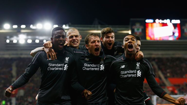 Divock Origi celebrates with team-mates Lucas Leiva and Jordon Ibe