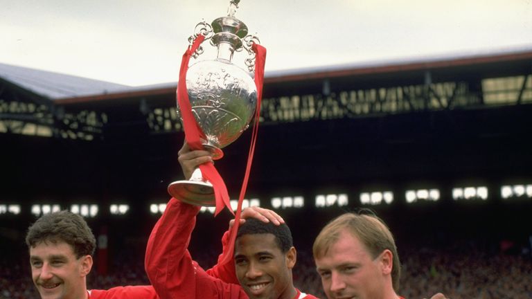 John Aldridge, John Barnes and Steve McMahon of Liverpool hold the League Champions trophy aloft in May 1988
