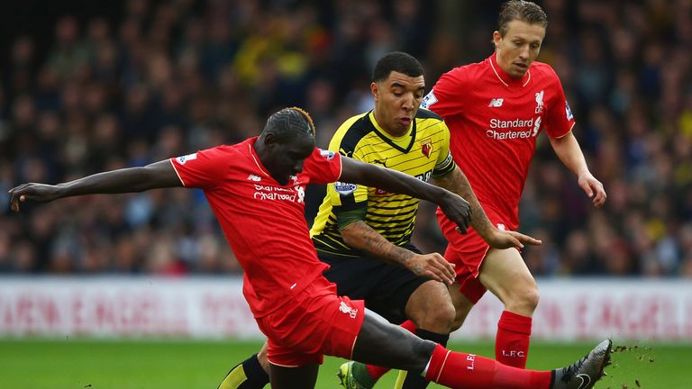 Troy Deeney of Watford takes on Mamadou Sakho and Lucas Leiva of Liverpool
